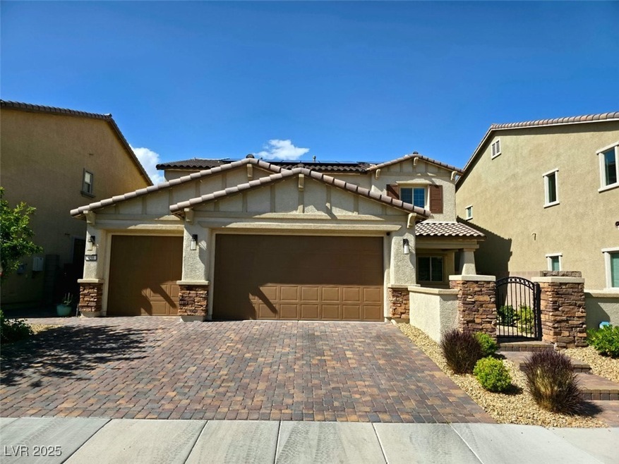 View of front of house featuring a garage, a tile