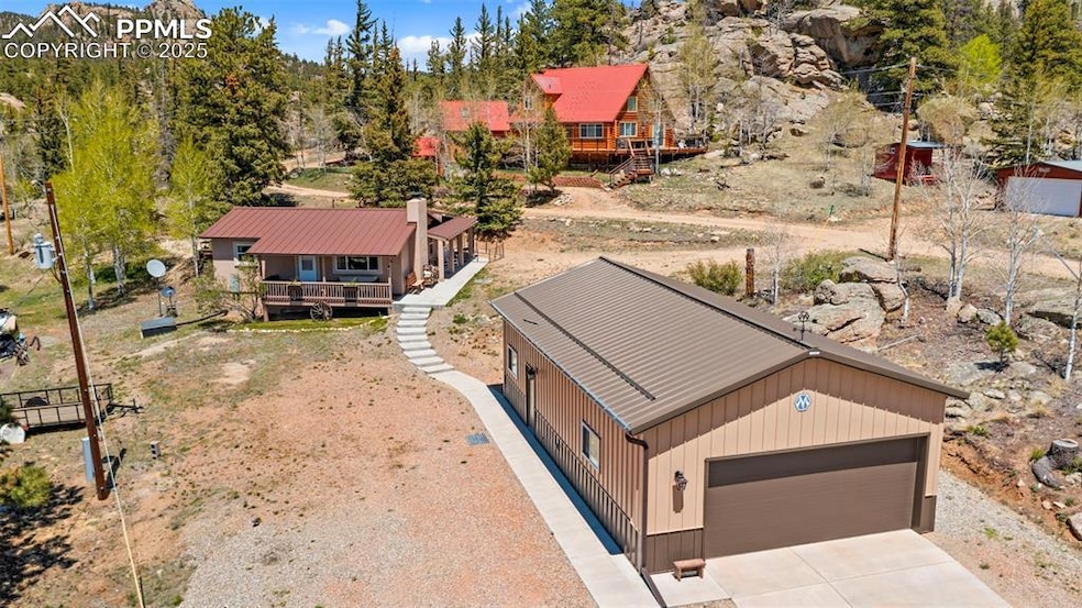 Rear view of house featuring a chimney, stucco siding, and a patio