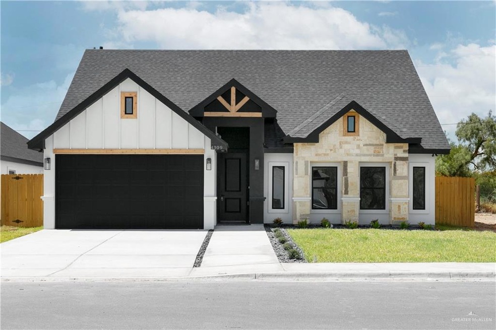 View of front of house with a garage and a front lawn
