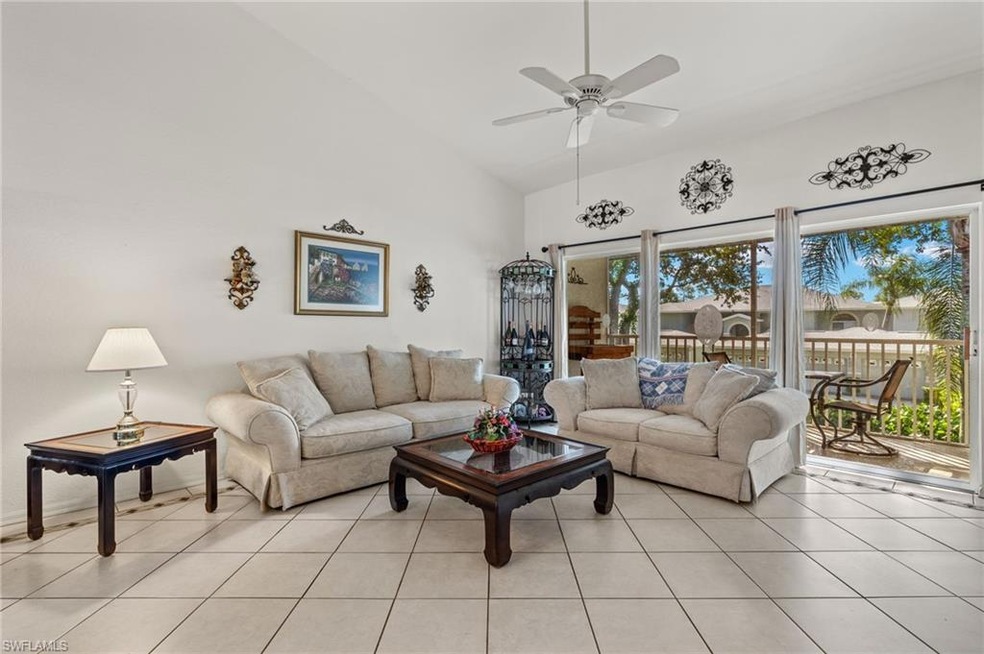 Living room with high vaulted ceiling, ceiling fan