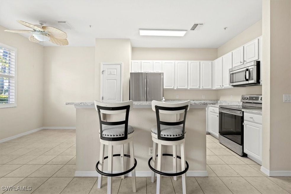 Kitchen featuring a kitchen island, a kitchen bar,