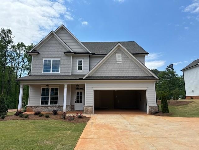 Craftsman inspired home featuring covered porch an