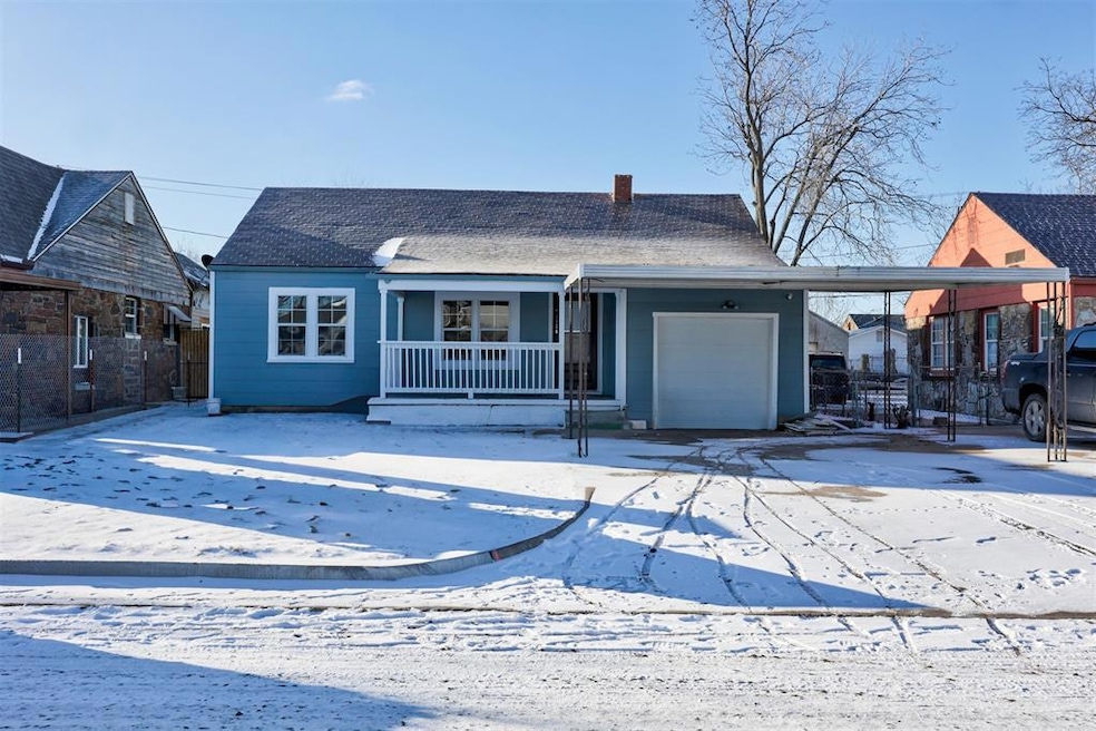 View of front of home featuring a chimney, covered