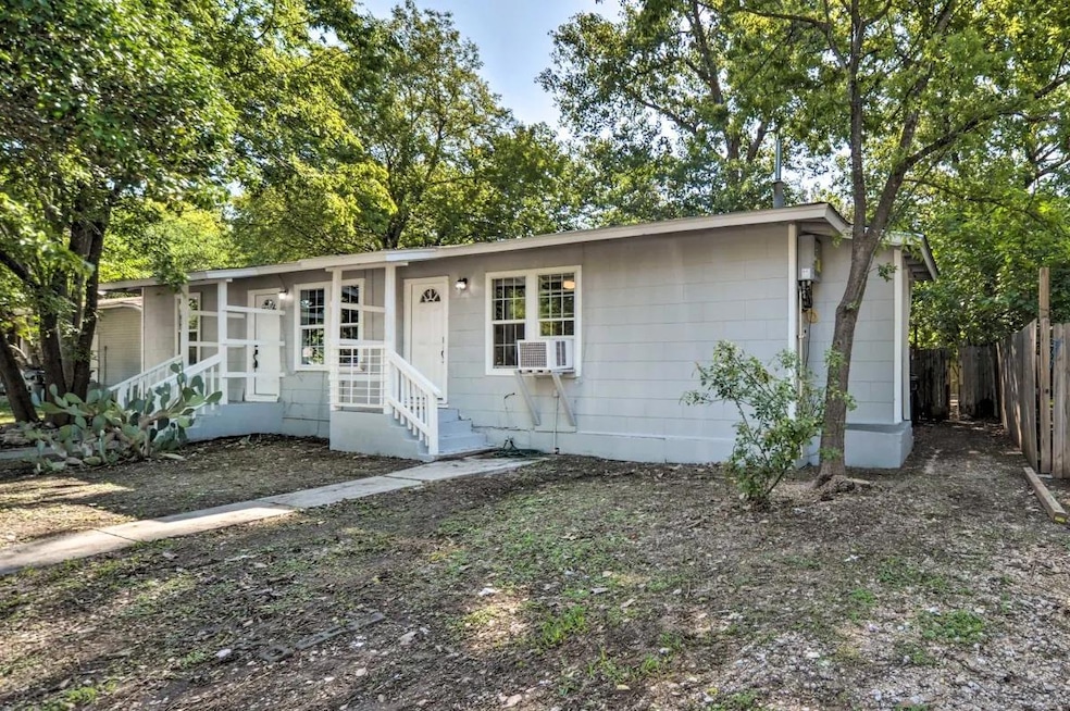 Single story home with cooling unit and fence