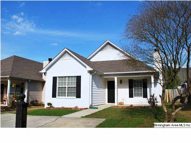 Cottage style exterior with painted brick accent a