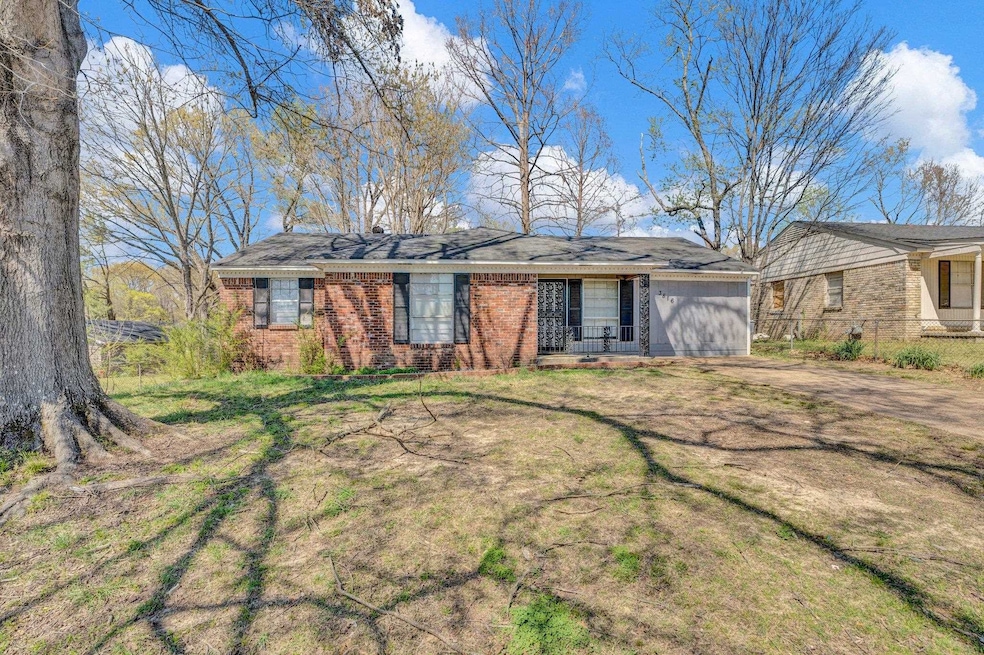 Single story home featuring brick siding, fence, a