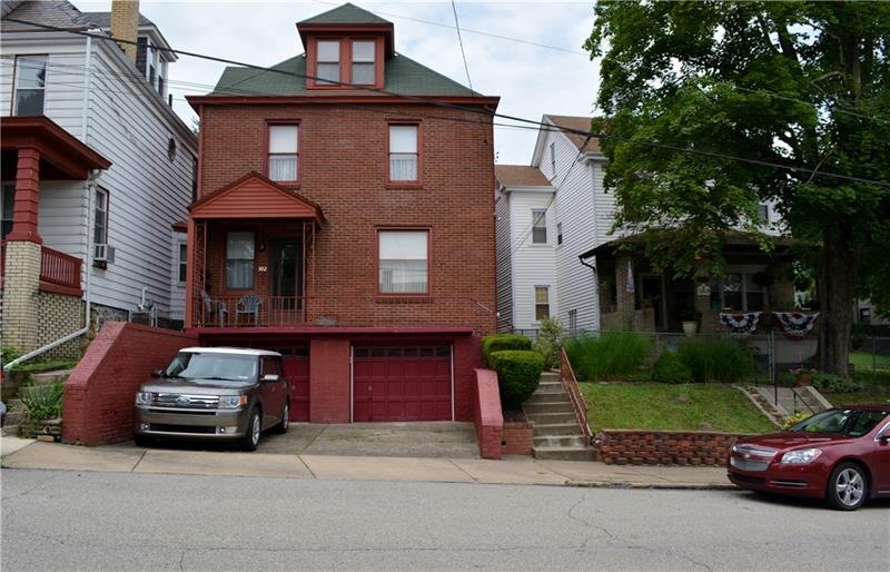 Brick triplex with 2 car integral garage.