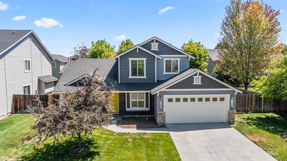 Craftsman house featuring driveway, stone siding, and a shingled roof