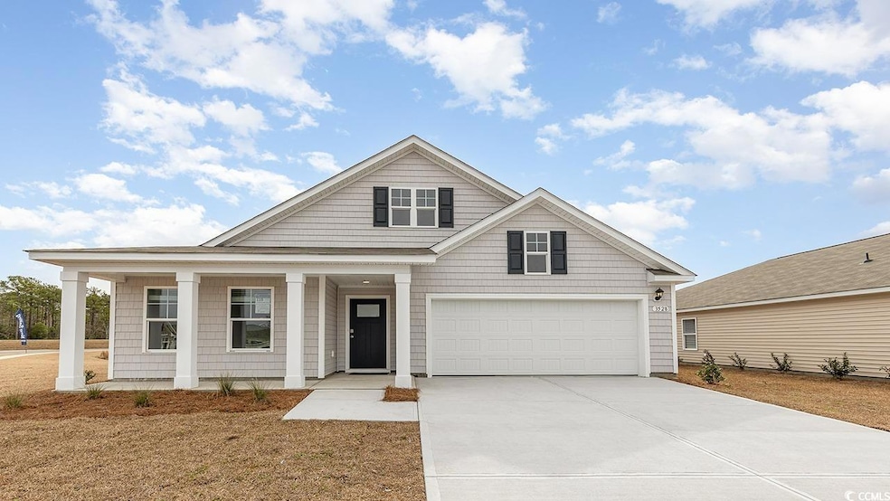 View of front of home featuring driveway, a porch,