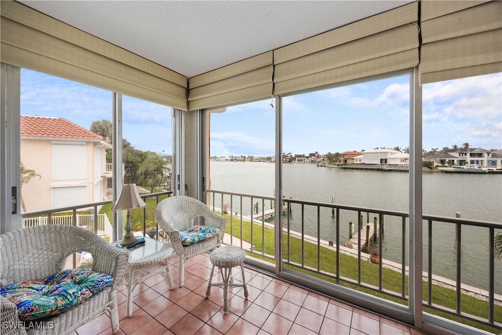 Sunroom with a healthy amount of sunlight and a water view