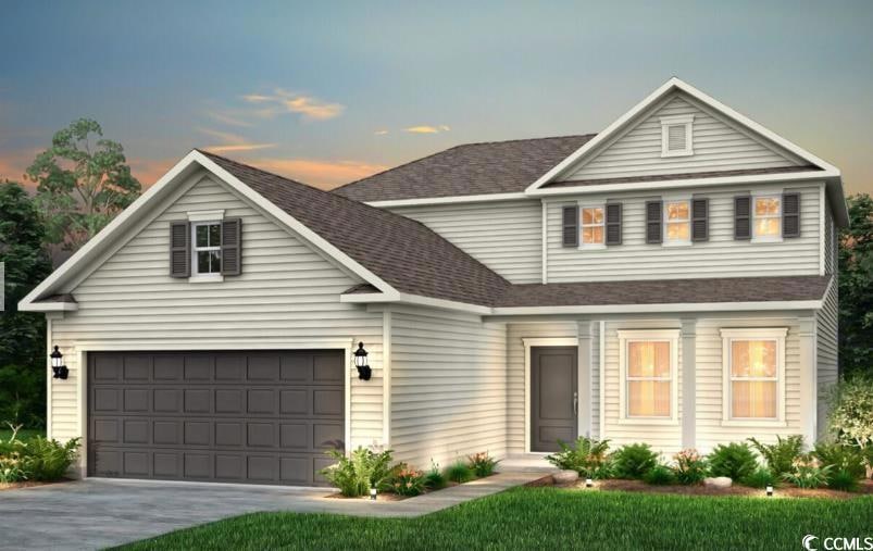 Traditional home with a garage, roof with shingles
