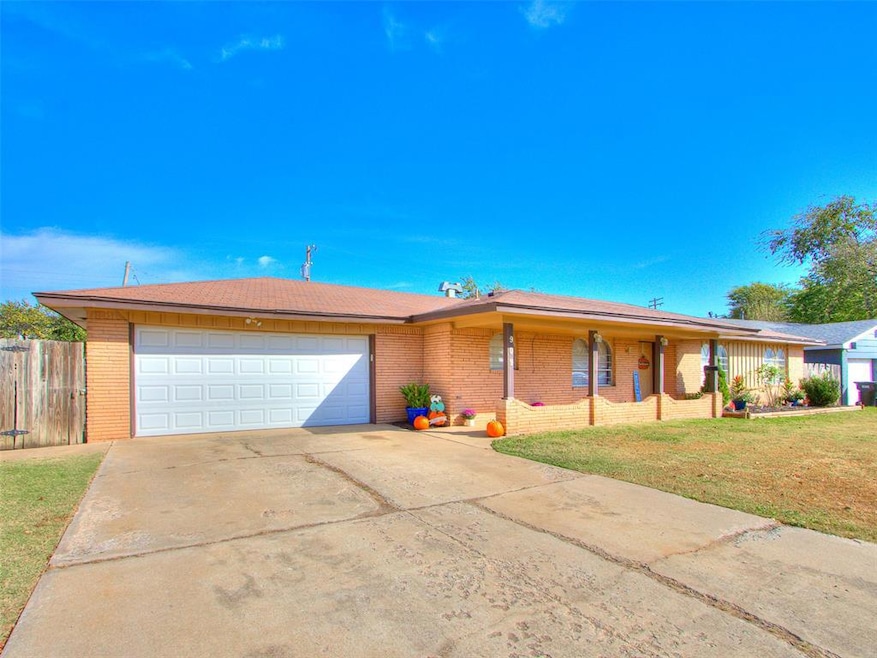 Single story home with brick siding, driveway, an attached garage, and covered porch