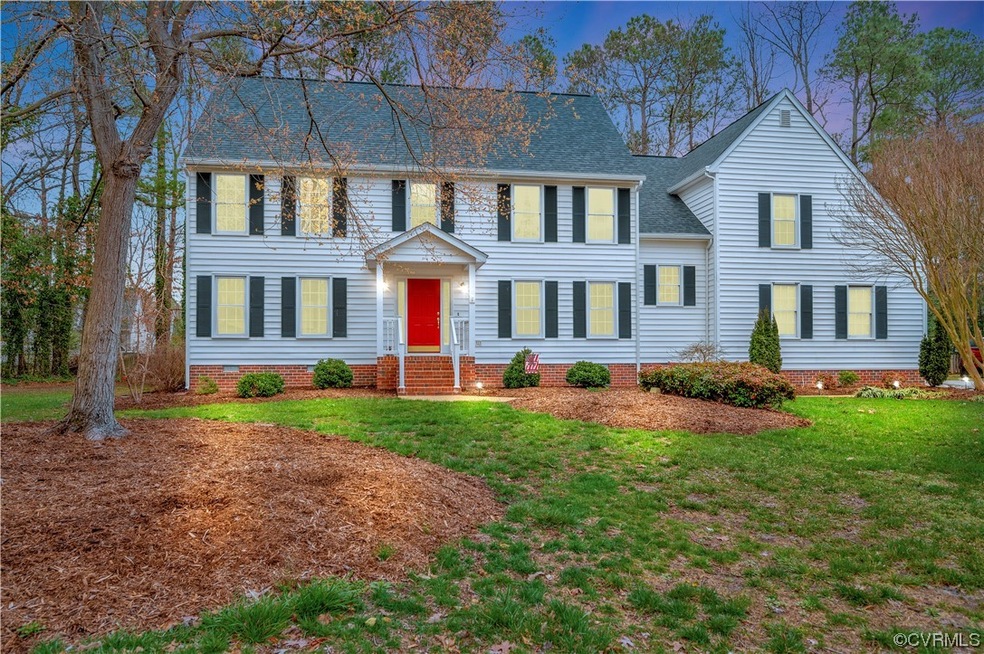 Colonial-style house with a front yard