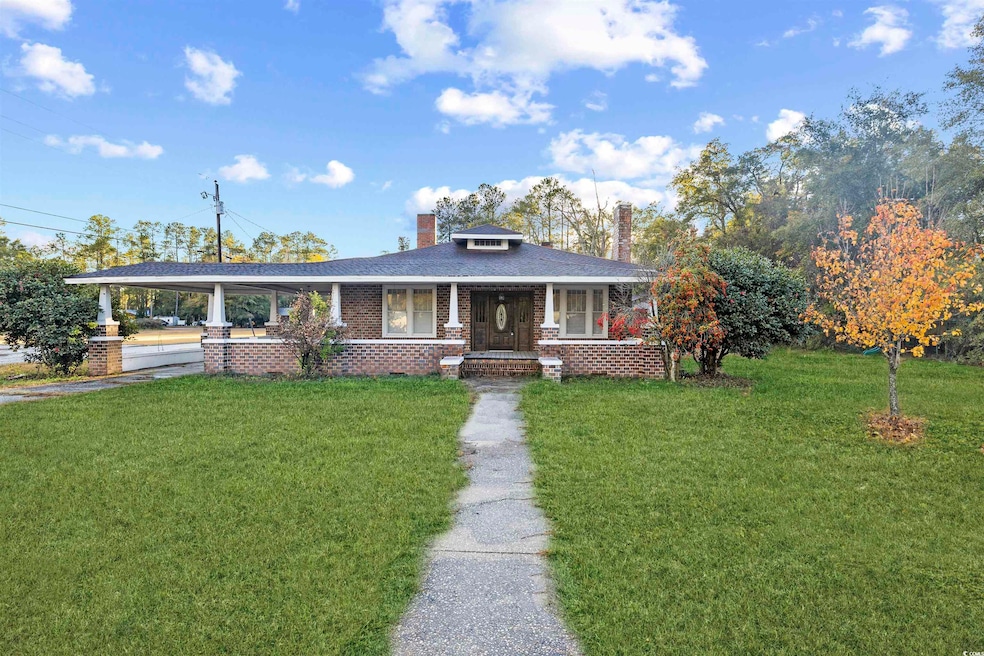 View of front of home featuring a front lawn and a porch
