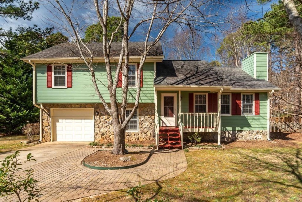 Tri-level home featuring covered porch, a front la