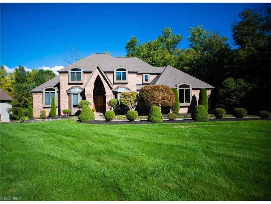 Exquisite custom home situated on a scenic wooded 