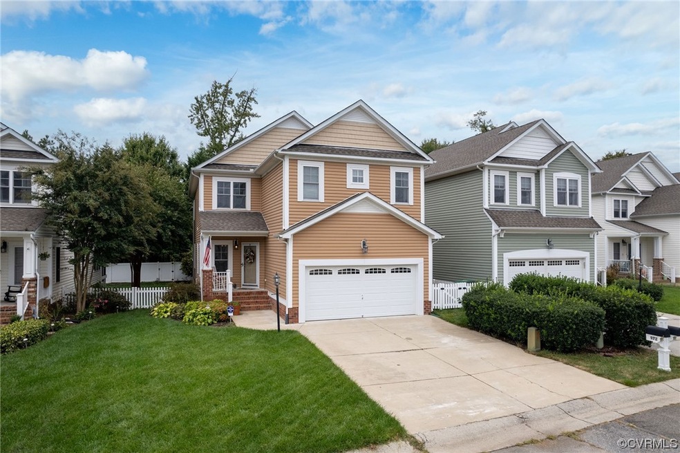 Craftsman-style home with a front yard and garage
