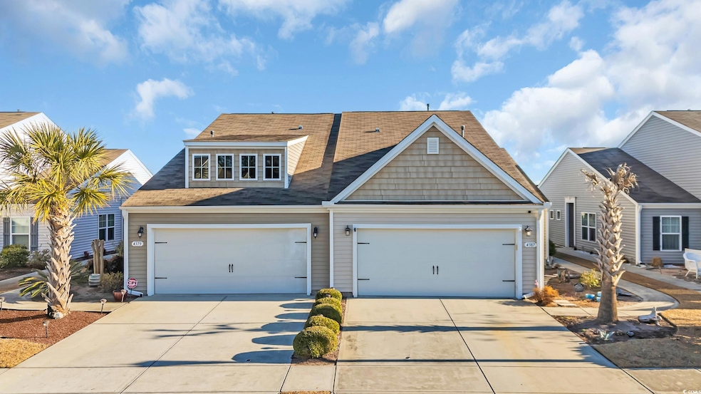 View of front facade featuring a garage