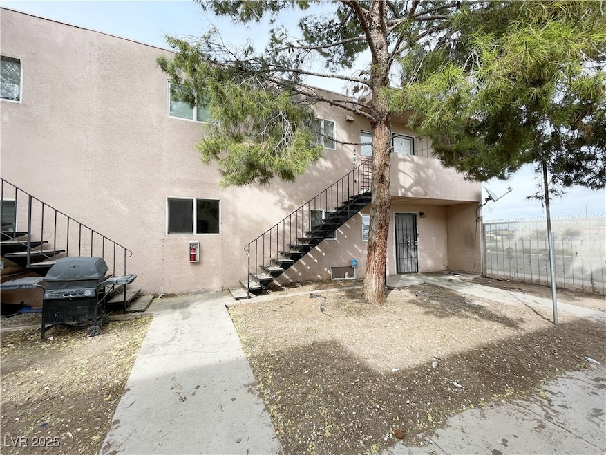 View of building exterior with stairs and fence