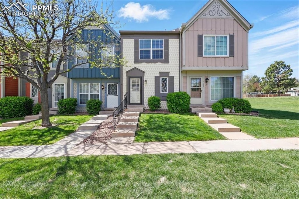 Multi unit property featuring board and batten siding and a front yard