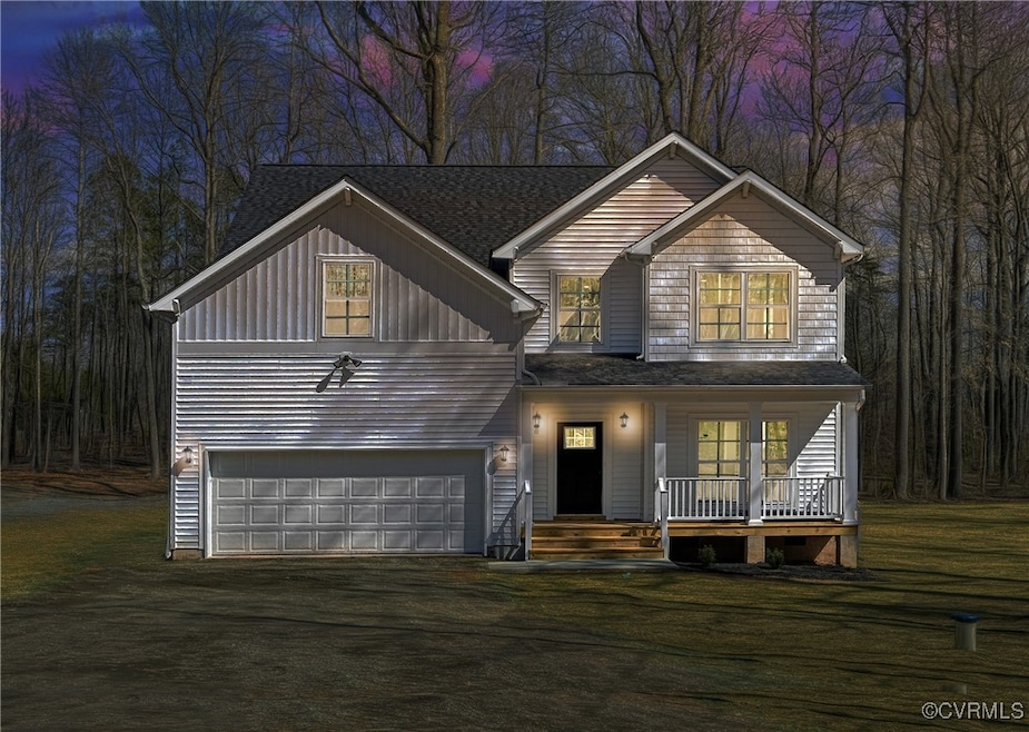 View of front of house with a garage, driveway, bo
