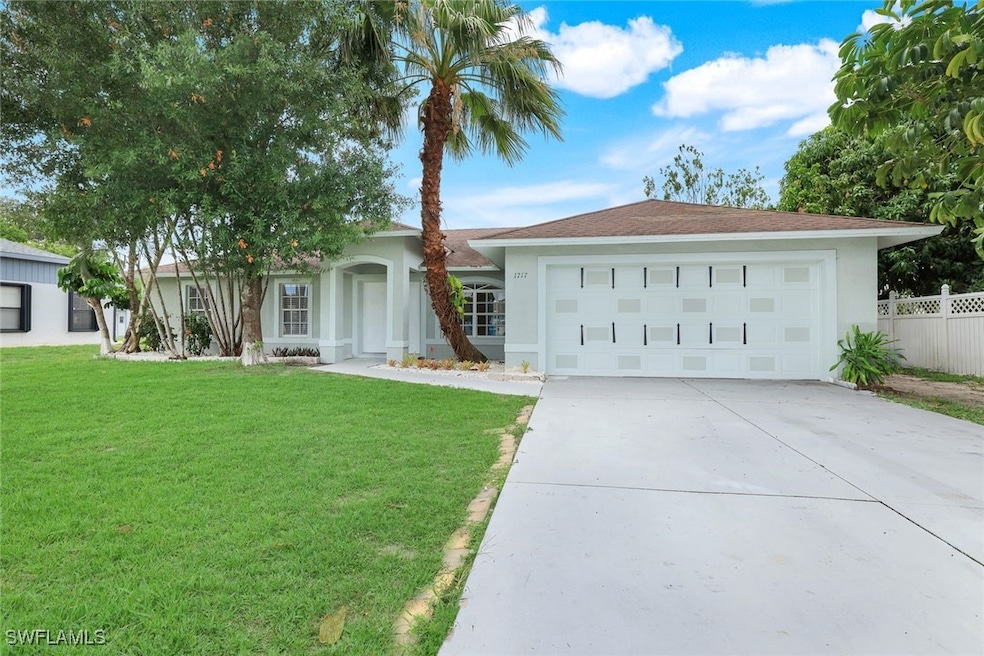 Single story home with stucco siding, driveway, a