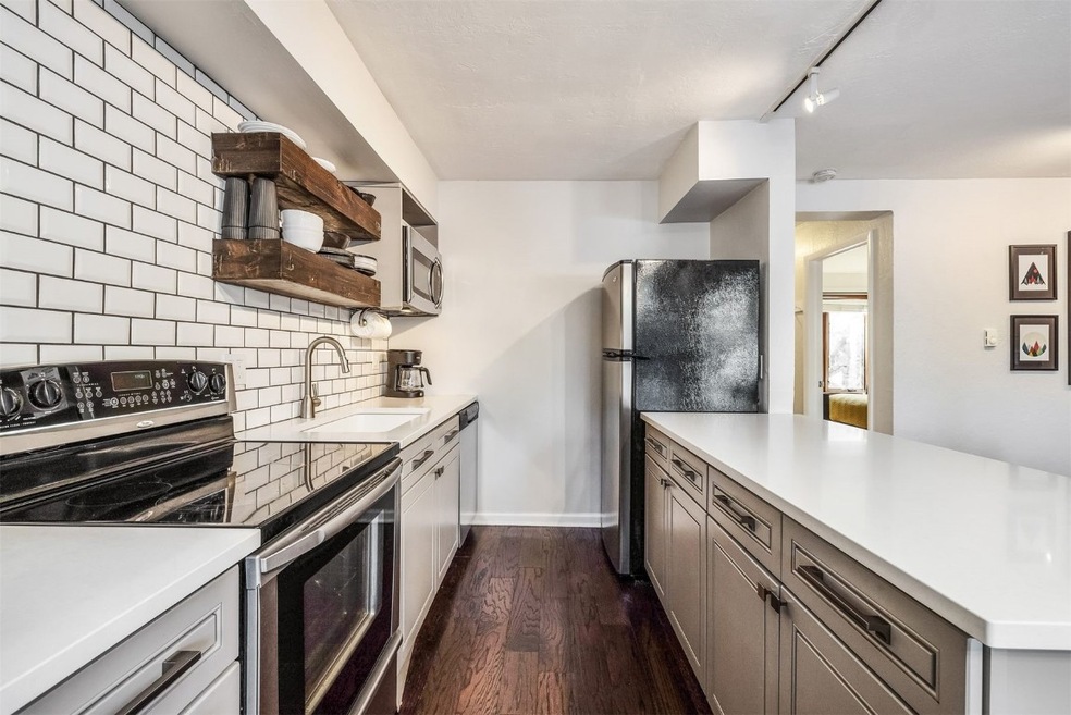 Kitchen with light countertops, open shelves, deco