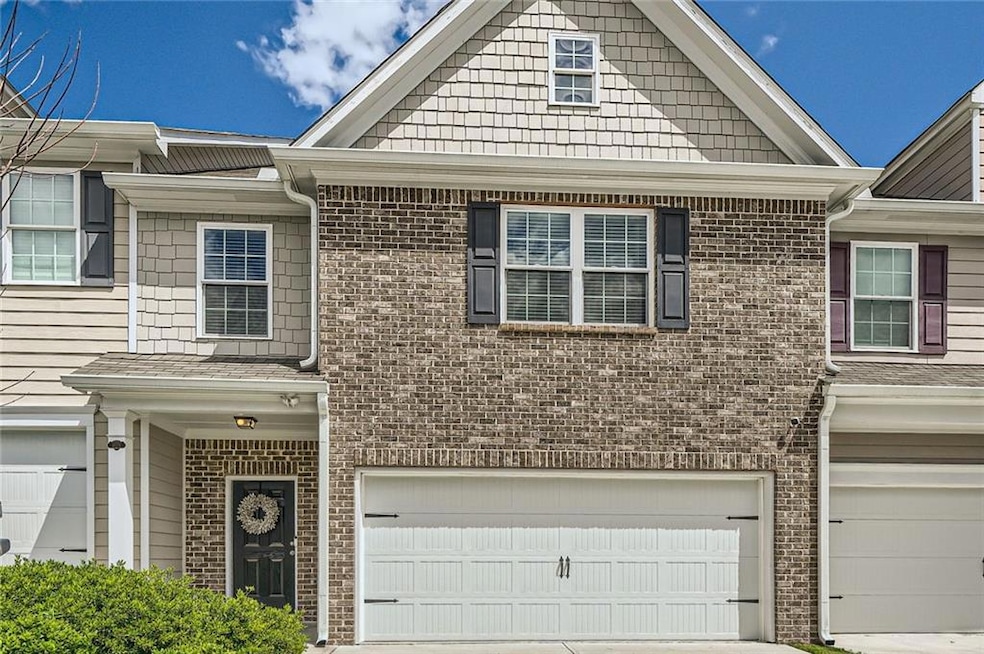Multi unit property with a garage, brick siding, a