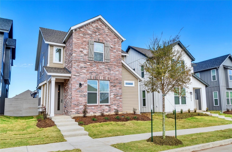 Traditional-style house with brick siding, roof wi
