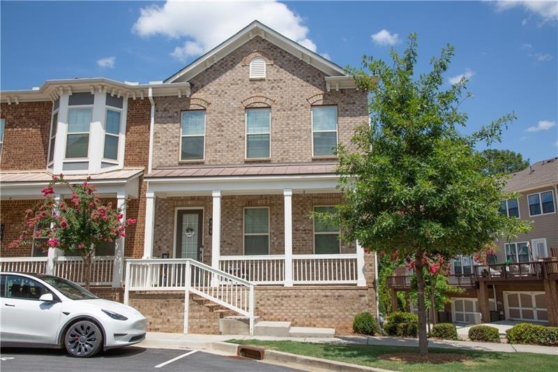 View of property with covered porch