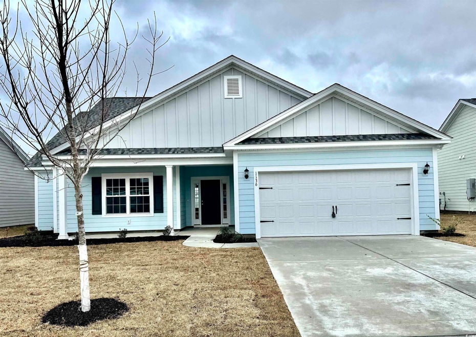 View of front of property with a garage, concrete 