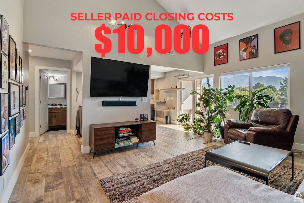 Living area with light wood-style flooring and baseboards