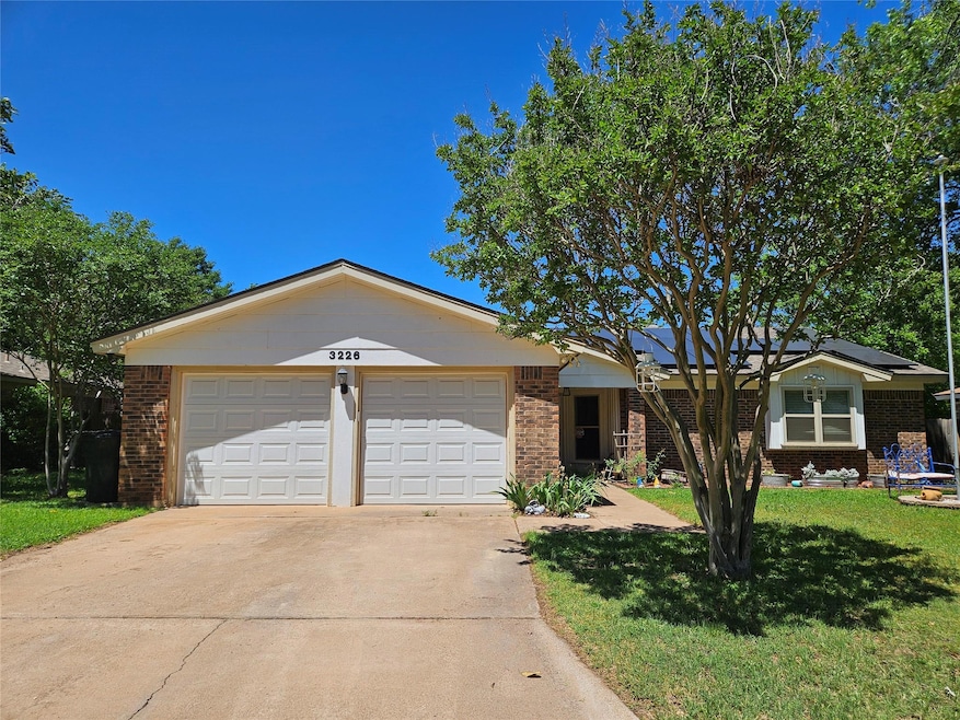 Ranch-style home with a front lawn and a garage