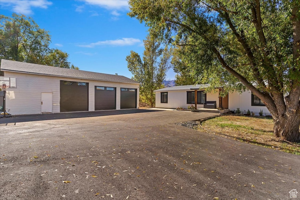 View of front of property featuring a garage and an outdoor structure
