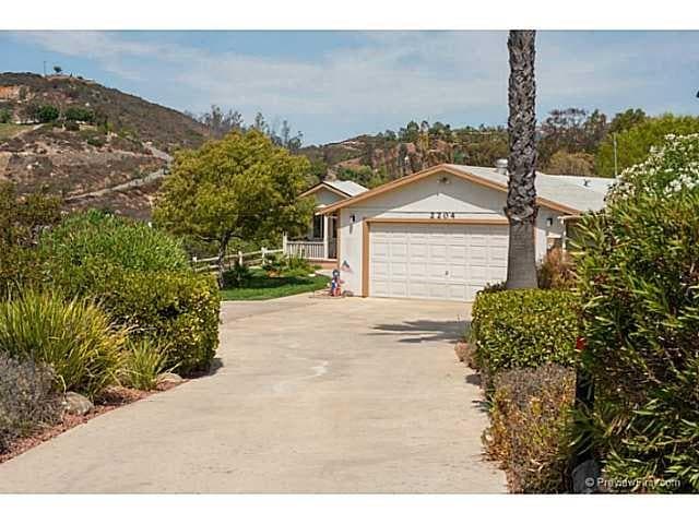 This 1 story home has a long private driveway into the lovely front of your home.