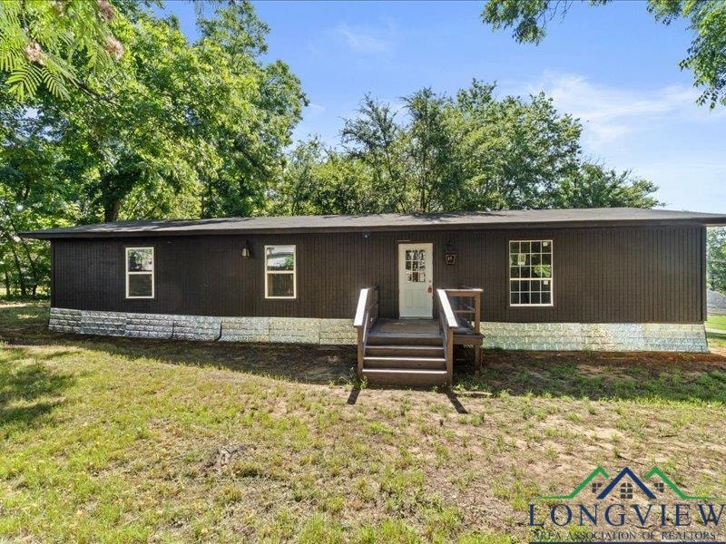 Home featuring a front lawn