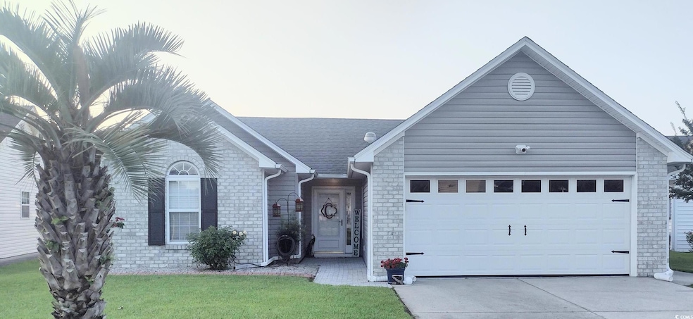 Ranch-style house featuring a garage, driveway, a front lawn, and brick siding