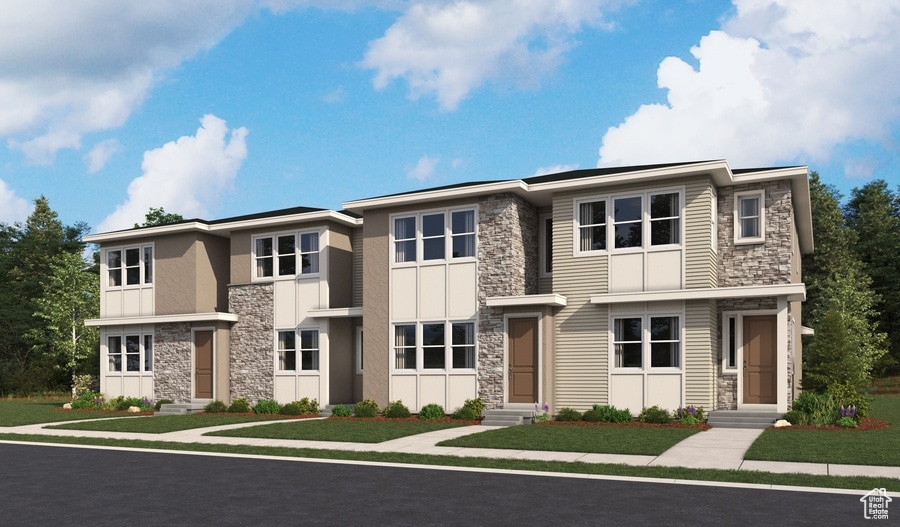 View of front of property with stone siding, entry steps, a front yard, and stucco siding