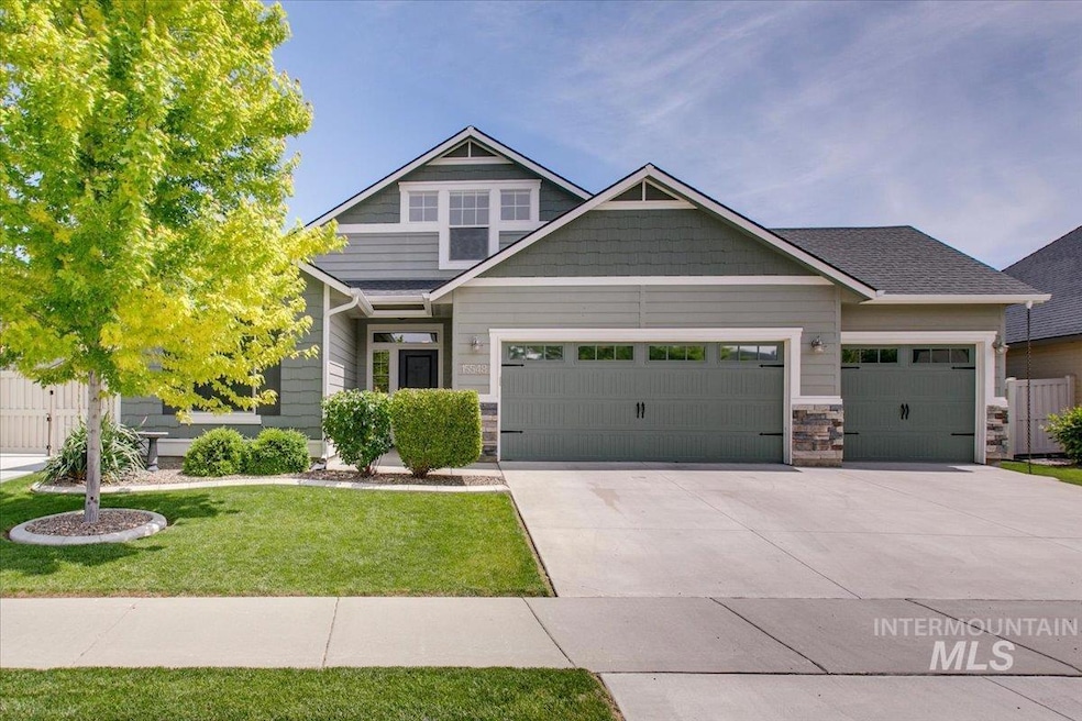 Craftsman-style home featuring a garage, driveway, a front lawn, and stone siding