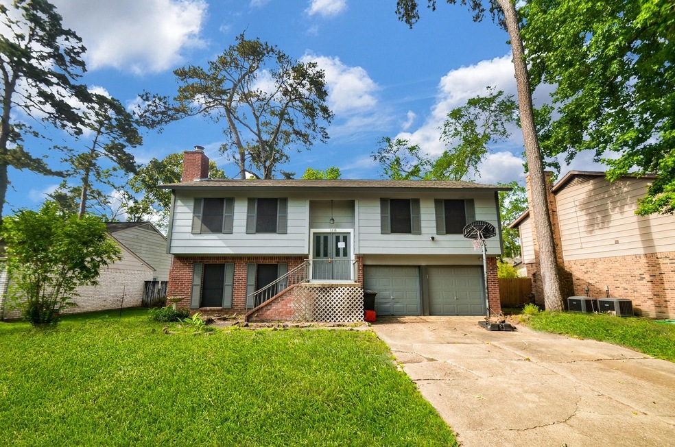 The dual vehicle attached garage sits atop a long,