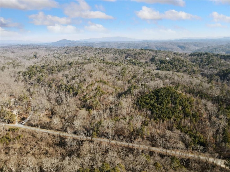 Birds eye view of property featuring a view of tre