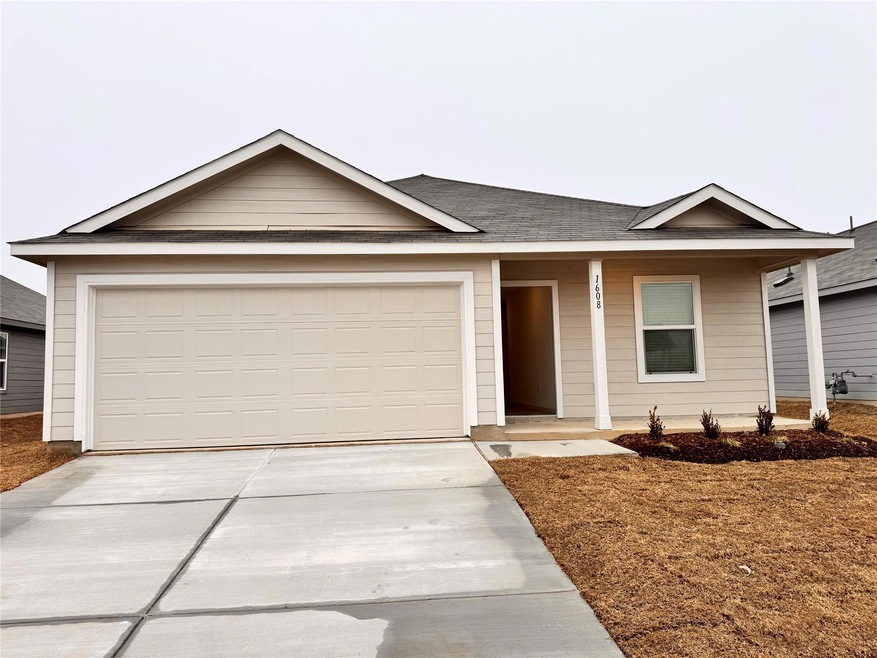 Ranch-style house with a garage and covered porch