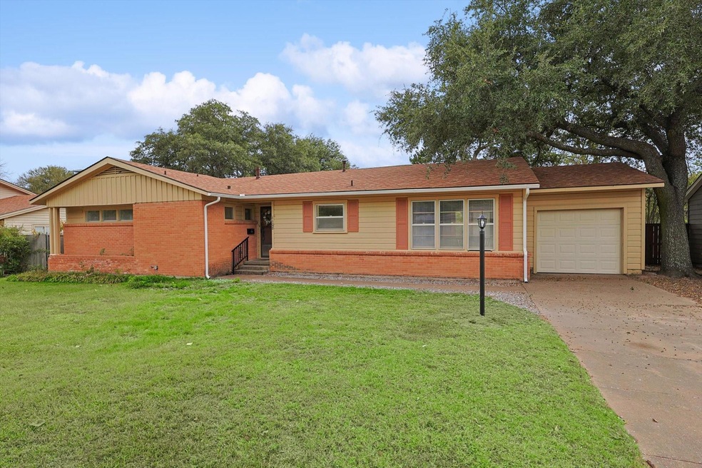 Ranch-style home with a front yard and a garage