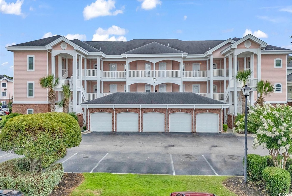 View of front of house with a garage and a balcony