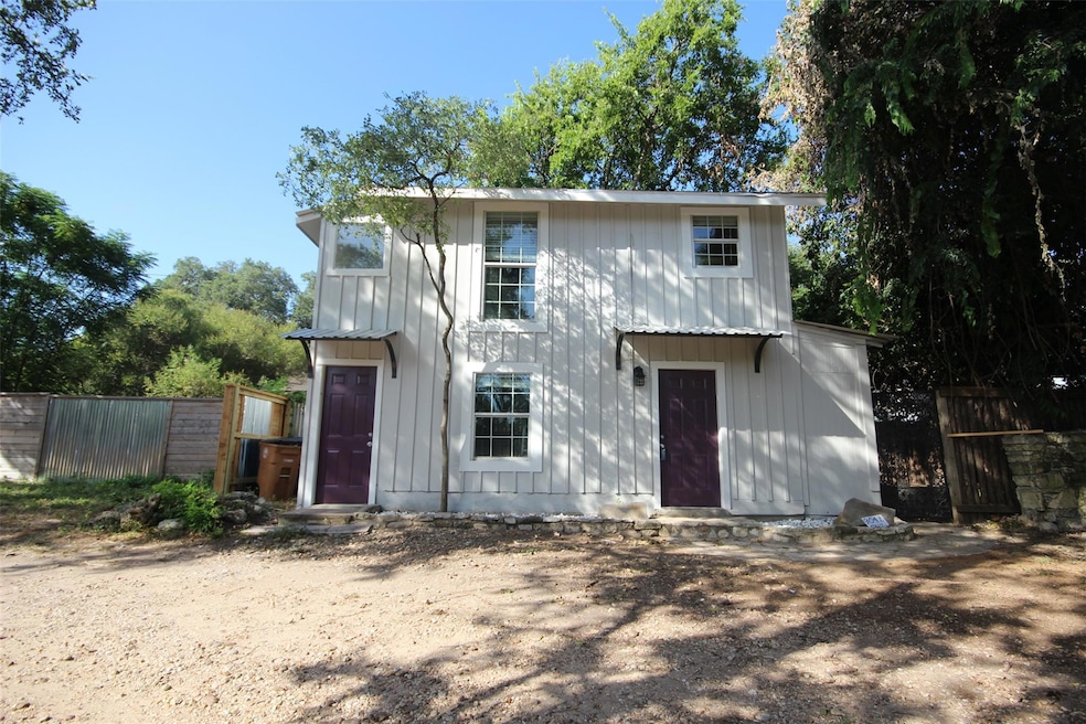 Back of house with fence and board and batten sid