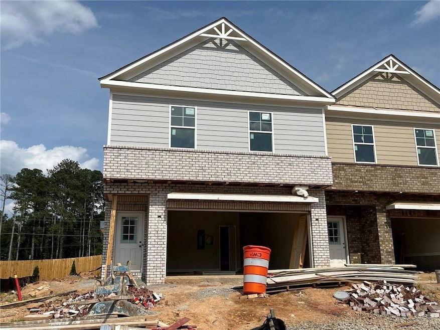 View of front of house with brick siding and a garage