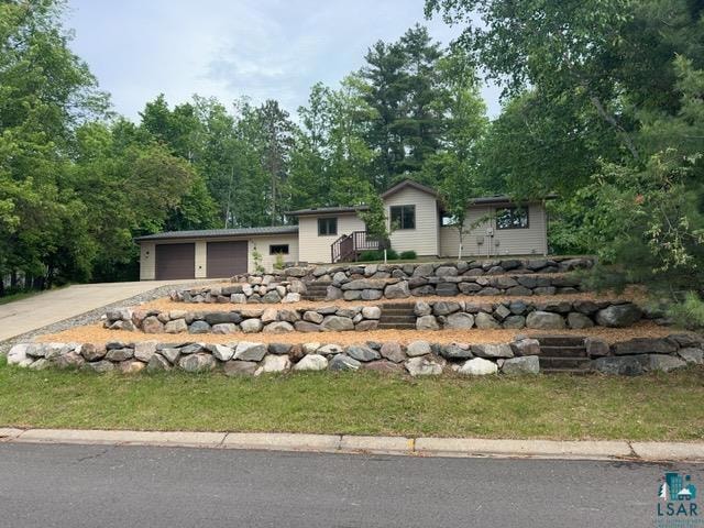 View of front of house with an attached garage and driveway