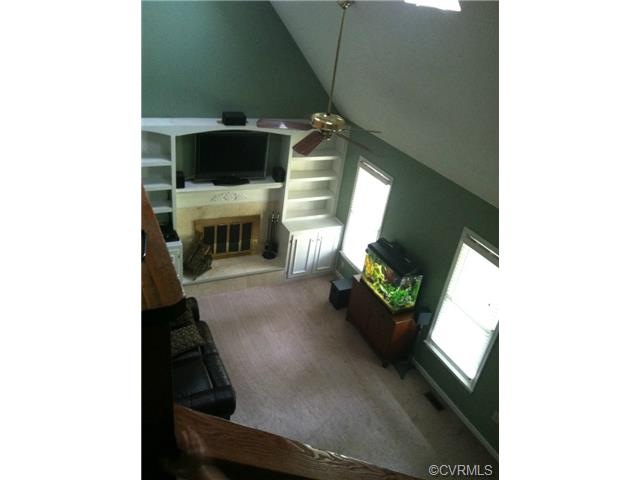 LOFTED CAPE WITH BUILT-IN BOOKCASES FLANKING THE F