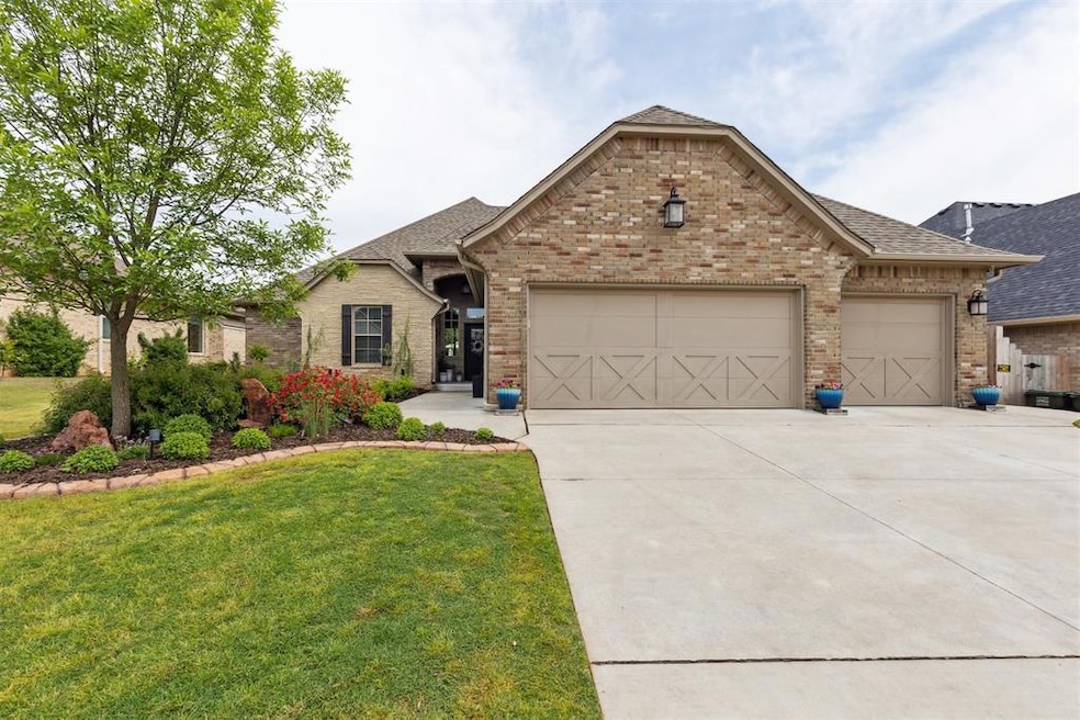 View of front of home featuring driveway, a garage