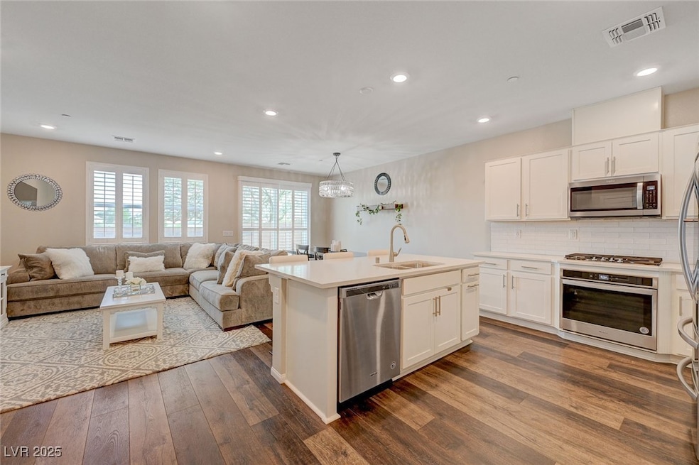 Kitchen with stainless steel appliances, a sink, d